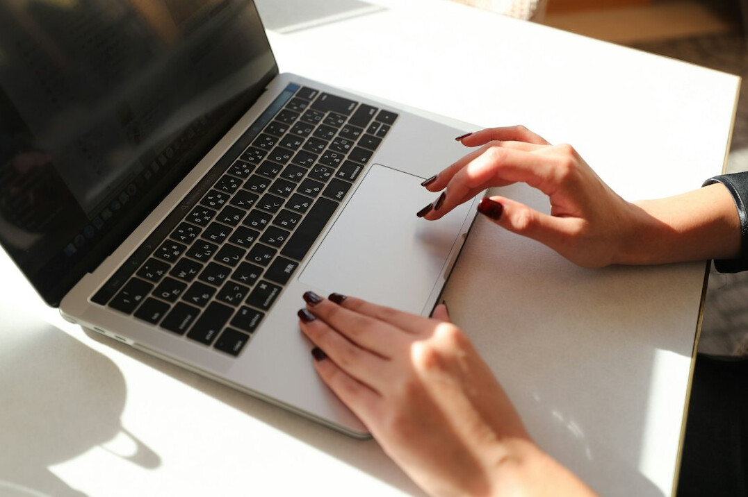 writer typing on laptop